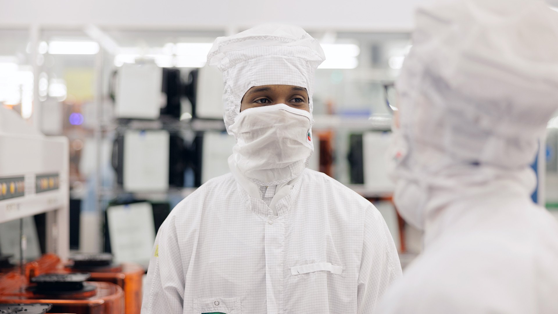 Technicians talking inside an ASML facility