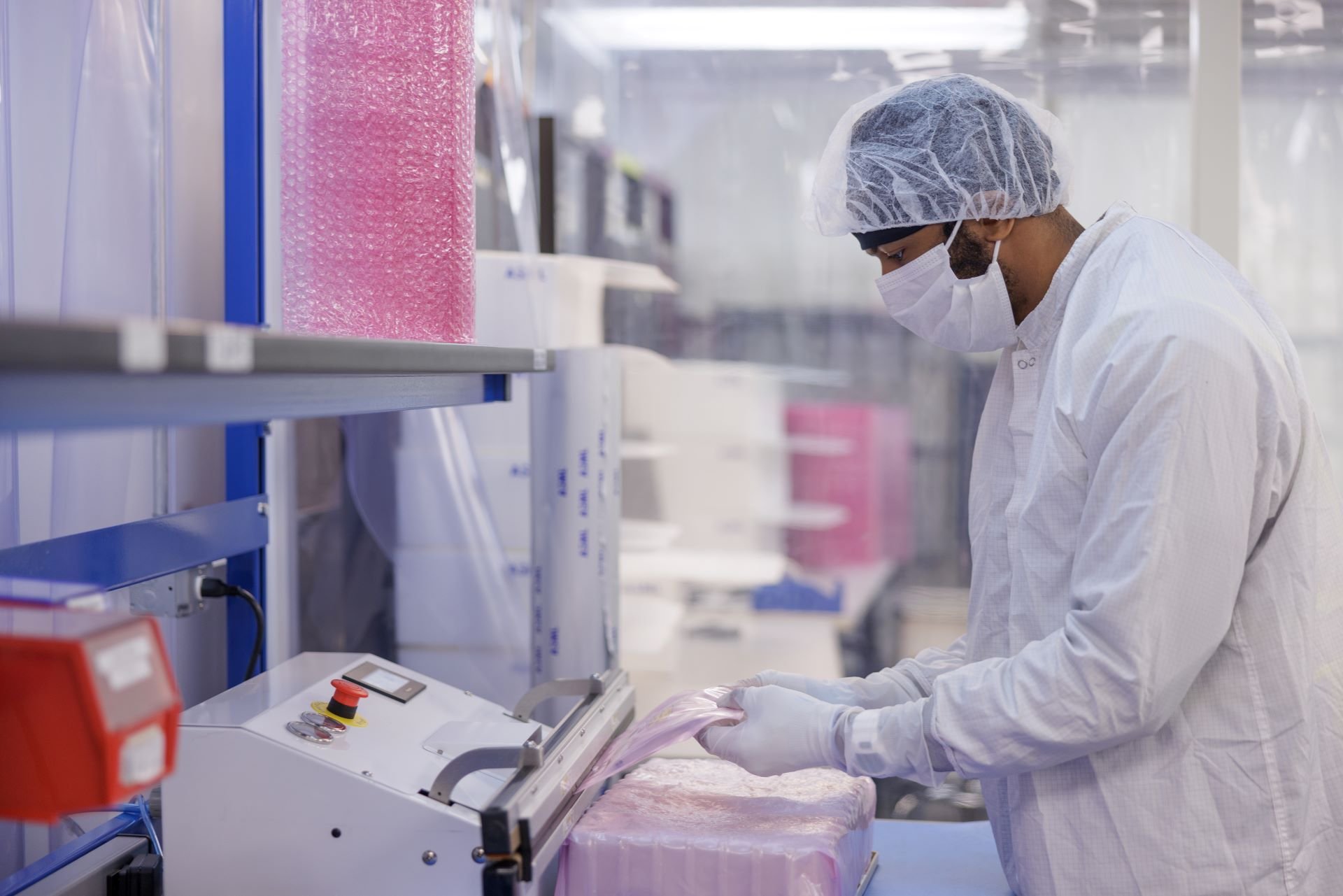 Technician operating equipment in a cleanroom
