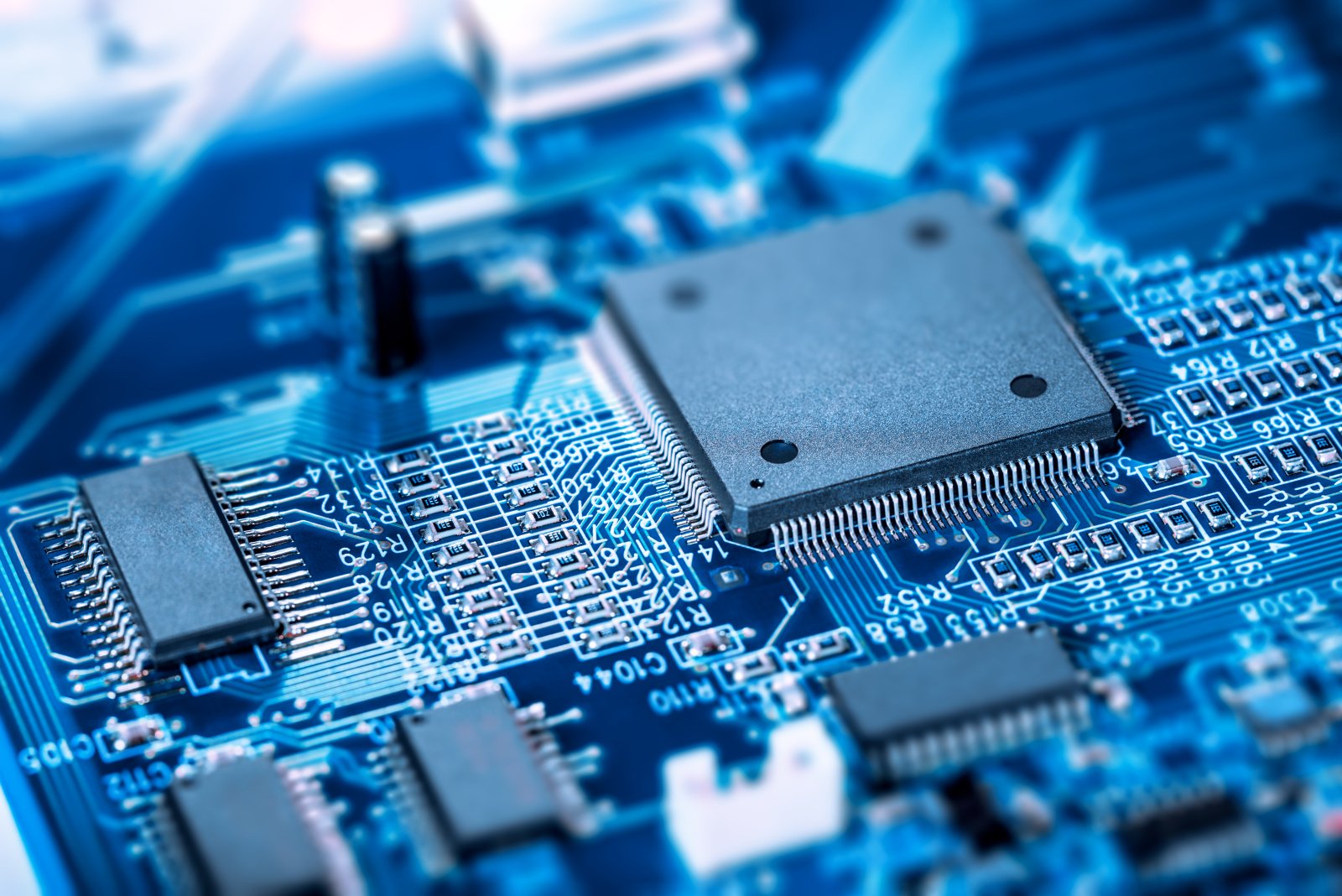 A motherboard with an embedded chip, showing circuits and connections.